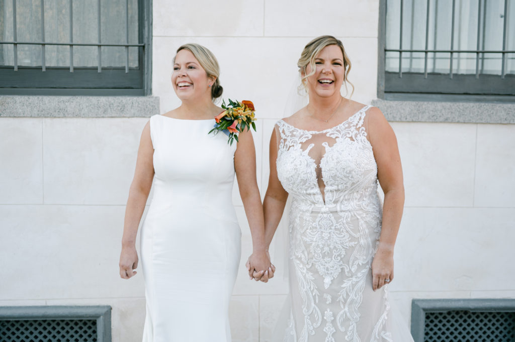 Two brides holding hands at their Margaret Place Hotel in New Orleans wedding