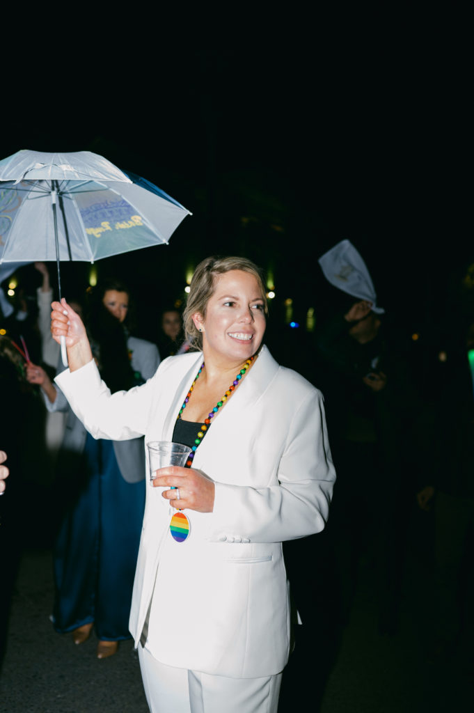 LGBTQ+ couple celebrating in a Second Line Parade after being married.