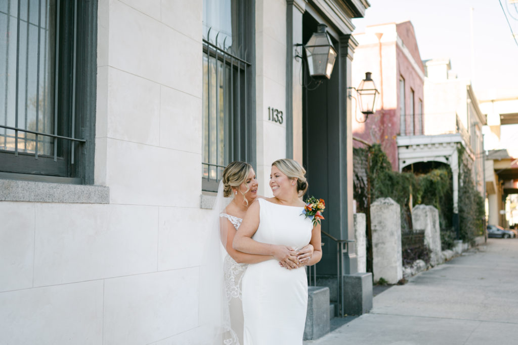 Two brides holding each other after eloping in New Orleans, LA.