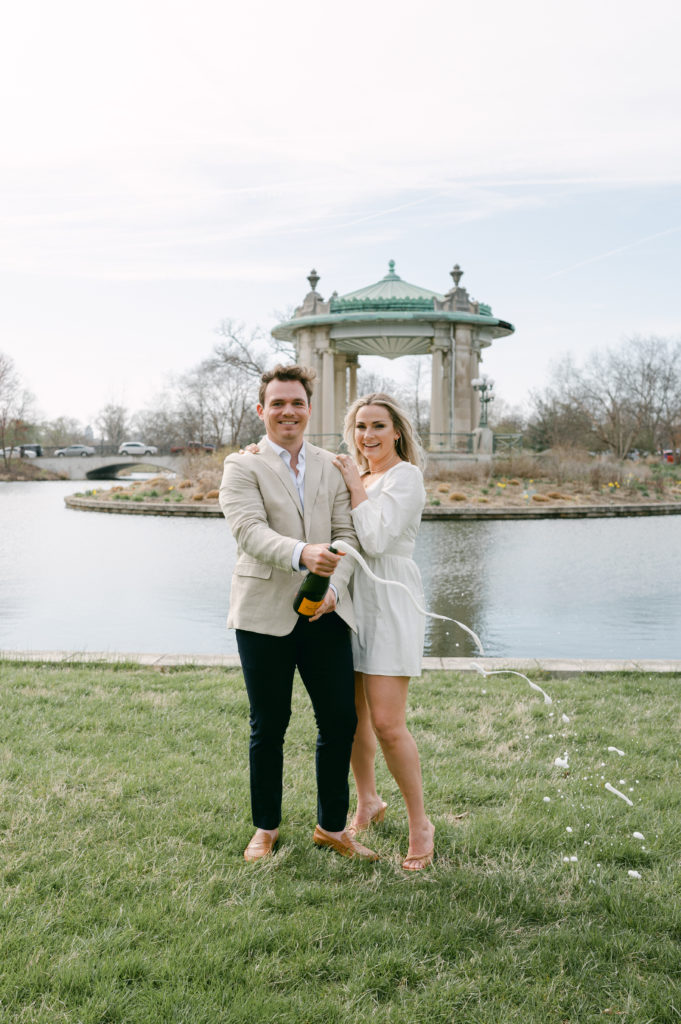 Champagne pop engagement session photos at Forest Park in St. Louis