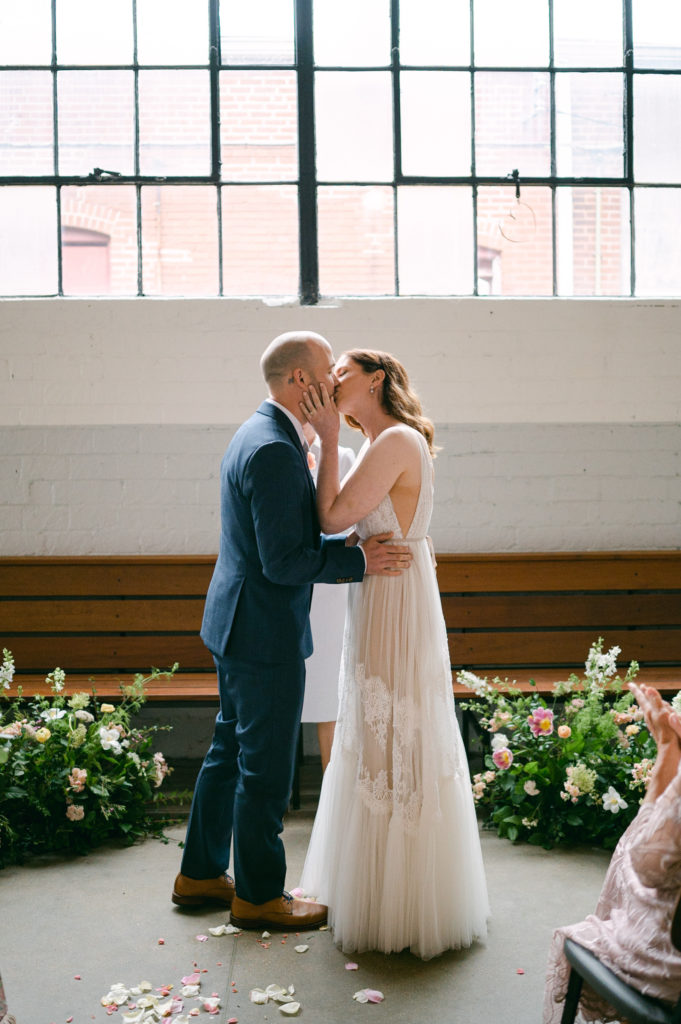 First kiss at Olive and Oak wedding
